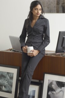 Middle Eastern businesswoman next to framed photography