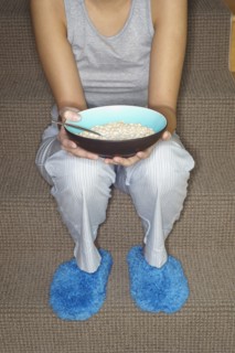 Asian woman eating cereal on stairs