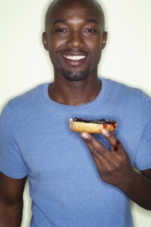 Portrait of African man eating bagel