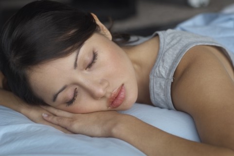 Close up of Hispanic woman sleeping in bed