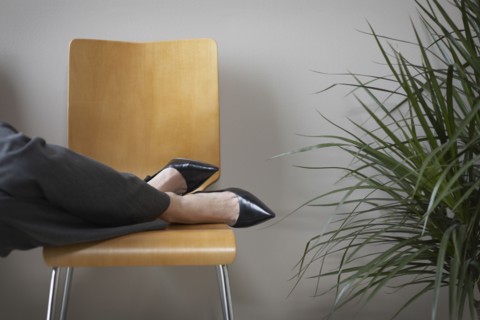 Close up of businesswoman's feet on chair