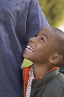 African boy smiling up at parent