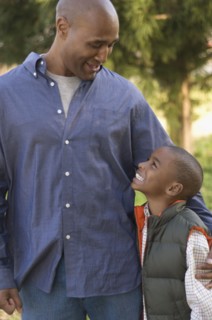 African father and son smiling at each other