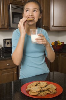 Hispanic girl eating cookies