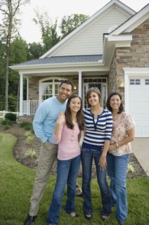 Hispanic family in front of house