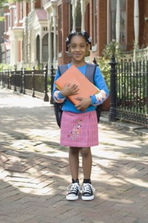 African girl holding school books