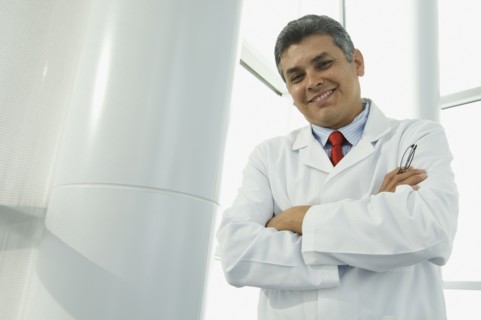 Hispanic male doctor with arms crossed