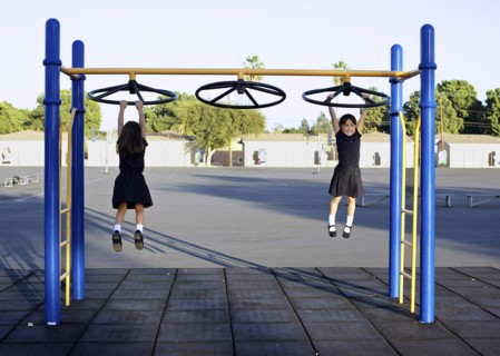 Twin girls playing on playground