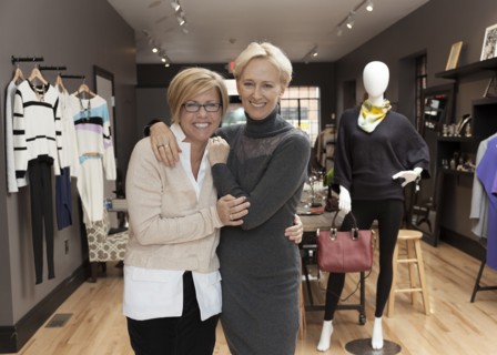 Caucasian small business owners working in clothing store