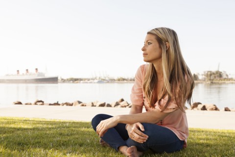 Caucasian woman sitting in park