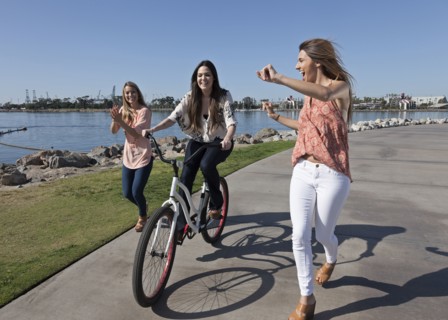 Women running and bike riding at waterfront