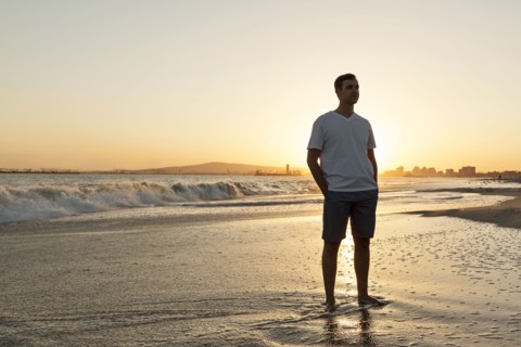 Caucasian man standing on beach