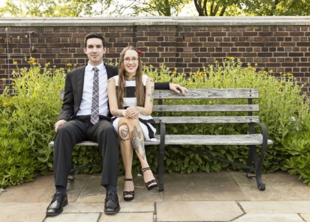 Well-dressed Caucasian couple sitting on bench at park