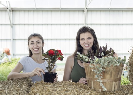 Portrait of Caucasian mother and daughter holding flowers