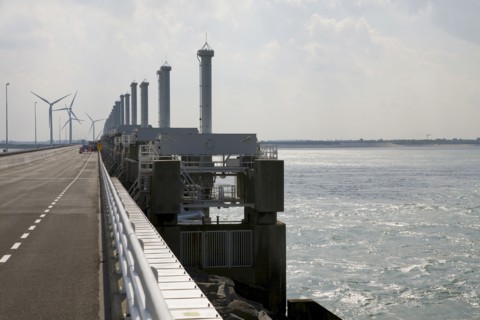 Wind turbines and dam across ocean