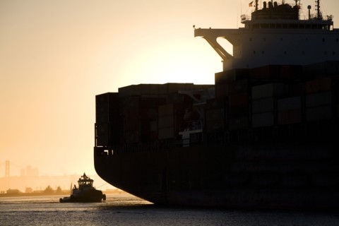 Tugboat and container ship in port of Oakland