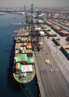 Cranes over container ship at commercial dock