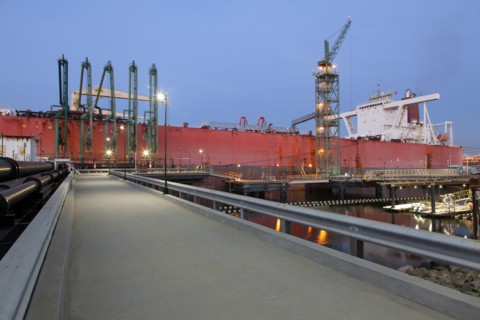 Concrete walkway to container ship in shipyard