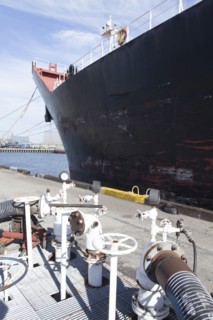 Oil tanker ship docked in industrial harbor