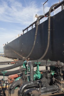 Oil tanker ship docked in industrial harbor