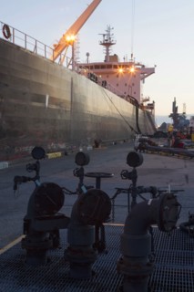 Oil tanker ship docked in industrial harbor