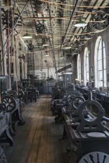 Pulleys and machinery in empty old-fashioned factory