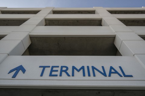 Arrow and terminal sign on parking garage
