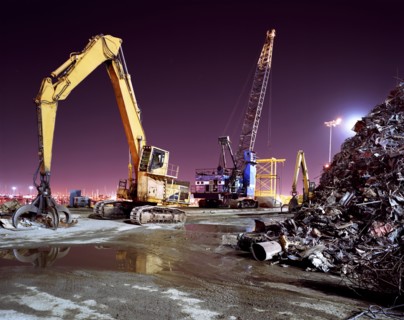Mechanical grabber in junkyard at night