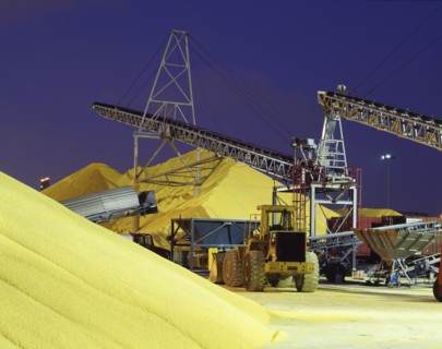 Bulldozer near piles of grain