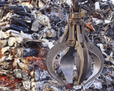 Mechanical grabber in junkyard at night