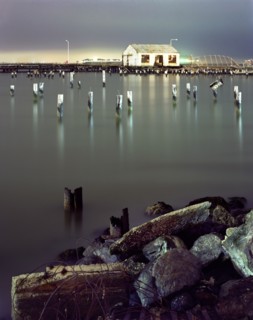 Pillars in still water at night