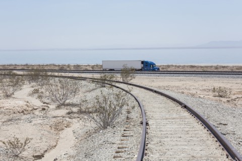 Semi-trick driving near railroad track