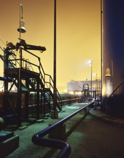 Blue industrial pipes and storage tank