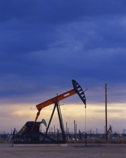 Oil rig drilling at sunset