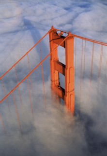 Aerial view of orange bridge over fog