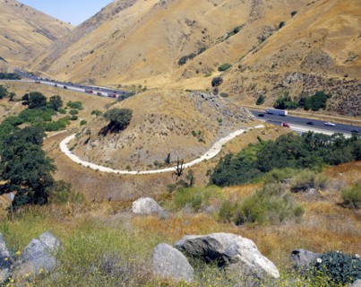 Path around hill near freeway