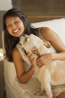 Dog licking Asian woman