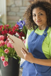 Mixed race florist holding clipboard