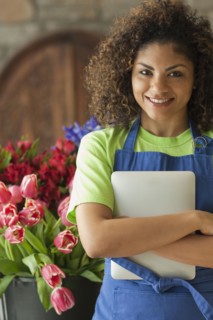 Mixed race florist holding digital tablet