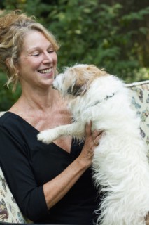 Caucasian woman playing with dog
