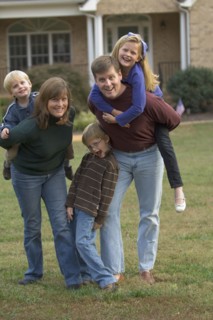 Family playing together on front lawn