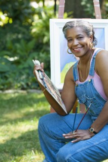 Black artist painting outdoors