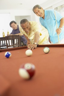 Multi-ethnic group of friends playing pool