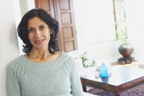 Confident Middle Eastern woman in living room