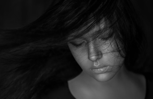 Wind blowing hair of Caucasian woman
