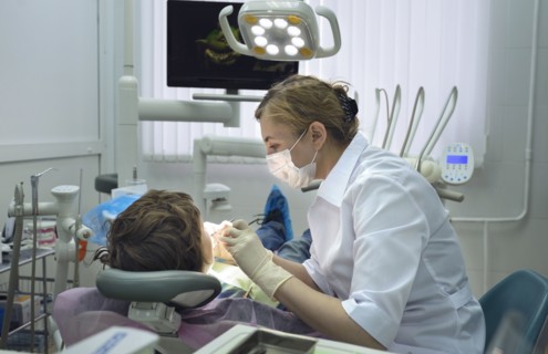 Dentist treating boy