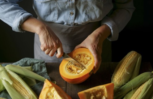 Close up of Caucasian woman cutting squash