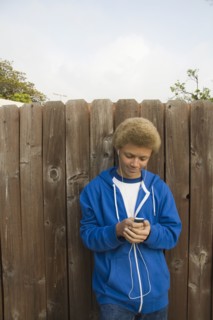 Mixed race boy listening to mp3 player