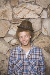 Mixed race boy wearing fedora