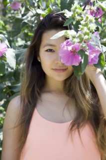 Asian woman hiding behind flower
